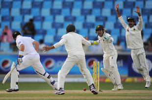 Ian Bell fell to Saeed Ajmal yet again as Pakistan fought back after crumbling for 99 on a wicket-filled first day in Dubai