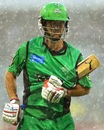 Rob Quiney protects his bat as he runs through heavy rain, Perth Scorchers v Melbourne Stars, Big Bash League, Perth, December 12, 2012