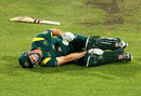 Shaun Marsh writhes in pain after hurting his knee completing the run for his hundred, Australia A v England Lions, Hobart, February 16, 2013