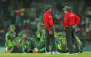 The players and umpires stand in the middle of the playing area after crowd trouble halted play, 3rd ODI, Colombo, July 19, 2015 The players and umpires stand in the middle of the playing area after crowd trouble halted play, 3rd ODI, Colombo, July 19, 2015
