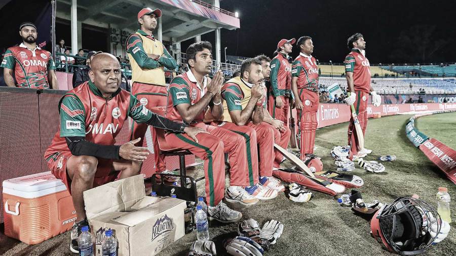 Oman team members look on from the dugout Oman team members look on from the dugout