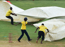 Ground staff at Sabina Park rush to cover the pitch during a spell of rain, West Indies v India, 2nd Test, Kingston, 4th day, August 2, 2016 Ground staff at Sabina Park rush to cover the pitch during a spell of rain, West Indies v India, 2nd Test, Kingston, 4th day, August 2, 2016