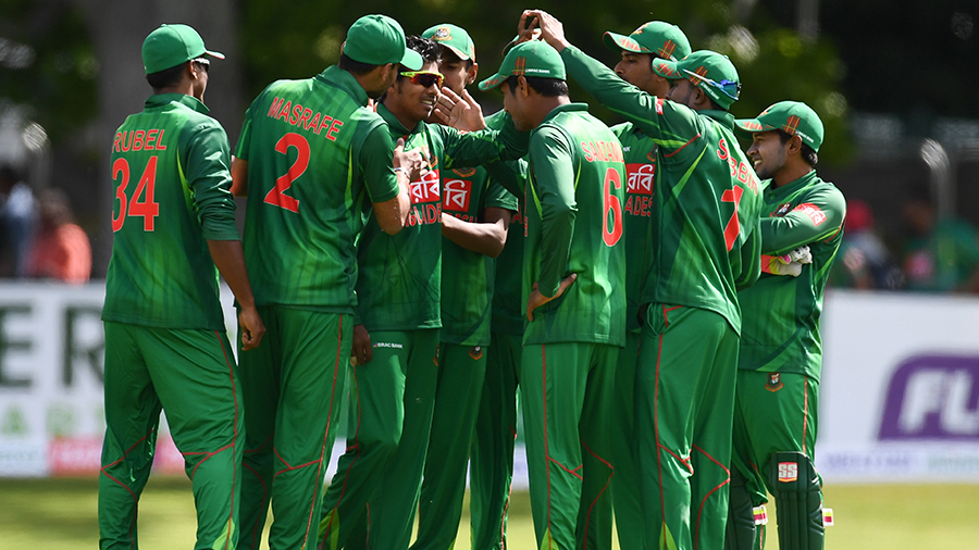 Team-mates mob Mosaddek Hossain after he dismissed William Porterfield Team-mates mob Mosaddek Hossain after he dismissed William Porterfield