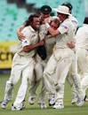 Got 'im! Australia mob Shane Warne after he wraps up the match with Makhaya Ntini's wicket, South Africa v Australia, 2nd Test, Durban, March 28, 2006