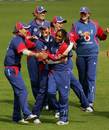 Isa Guha of England is congratulated by Charlotte Edwards, after bowling Nicola Browne of New Zealand during the fifth one-day International match between England and New Zealand at Blackpool Cricket Club