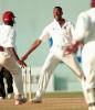 West Indies fast bowler Courtney Walsh (C) celebrates after taking his 435th wicket against Zimbabwe 27 March, 2000 in Kingston, Jamaica. Walsh broke the record held by India's Kapil Dev for most number of wickets