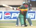 South African batsman Gary Kirsten sweeps a ball on his way to making 115 runs as Indian wicketkeeper Samir Dighe (partly covered) looks on during the first one-day international cricket match between India and South Africa in Cochin 09 March 2000. Despite centuries from both openers Kirsten and Herschelle Gibbs India went onto win the match by 3 wickets