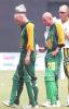 South African batsman Gary Kirsten (L) puts an ice pack on his head as the team physiotherapist attends to team-mate Herschelle Gibbs (C) during the drink's break in the first one-day international cricket match between India and South Africa in Cochin 09 March 2000. Despite centuries from openers Kirsten and Gibbs India went onto win the match by 3 wickets