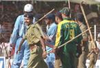 Riot police protect Indian cricketer Sachin Tendulkar (C) from pitch-invading fans 17 March 2000, after he scored a century against South Africa at the IPCL grounds in Baroda, India. India won the fourth of five matches in the series to take an unbeatable 3-1 lead