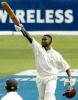 Wavell Hinds lifts his bat after reaching three figures against India at Jamaica