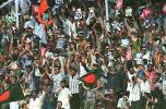 Local spectators at Dhaka's Bangabandhu National Stadium jubilate during the Bangladesh innings against India in the four-nations Asia Cup cricket. India beat Bangladesh by eight wickets. Asia Cup 1999/00, 2nd Match, Bangladesh v India, Bangabandhu National Stadium, Dhaka. 30-31 May 2000.