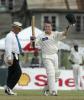 New Zealand batsman Scott Styris raises his bat and helmet to celebrate reaching his century on debut. Styris went on to score 107 in his first innings. 2nd Test: West Indies v New Zealand at Queen's Park, St George's, Grenada, 28 June-2 July 2002 (29 June 2002).