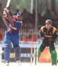 Sri Lankan batsman Avishka Gunawardene drives the ball on 11 July 2000 on his way to scoring 87 in the match against South Africa in the Singer Triangular series in the Sri Lankan capital of Colombo as wicket keeper Mark Boucher looks on. Sri Lanka won the match by eight wickets.