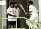 Yasir Hameed (R) is congratulated by coach Javed Miandad (L) and the team doctor as he walks into the dressing room, after scoring his second century during the last day play of the first Test match between Pakistan and Bangladesh in Karachi, 24 August 2003.