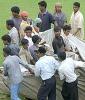 Groundsmen pulling the covers as rain washes out play on the second day, Board President's XI v New Zealand tour match, day two, Visakhapatnam, 270903