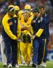 Shane Warne is carried off the field after injuring his shoulder attempting a full-length dive to field the ball during Australia's VB series match with England, Melbourne, 15 Dec 2002