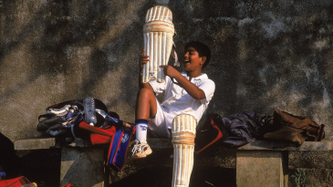 A young cricketer pads up