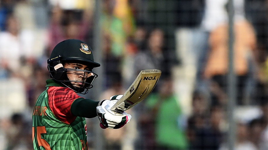 Mushfiqur Rahim raises his bat after getting to his half-century Mushfiqur Rahim raises his bat after getting to his half-century