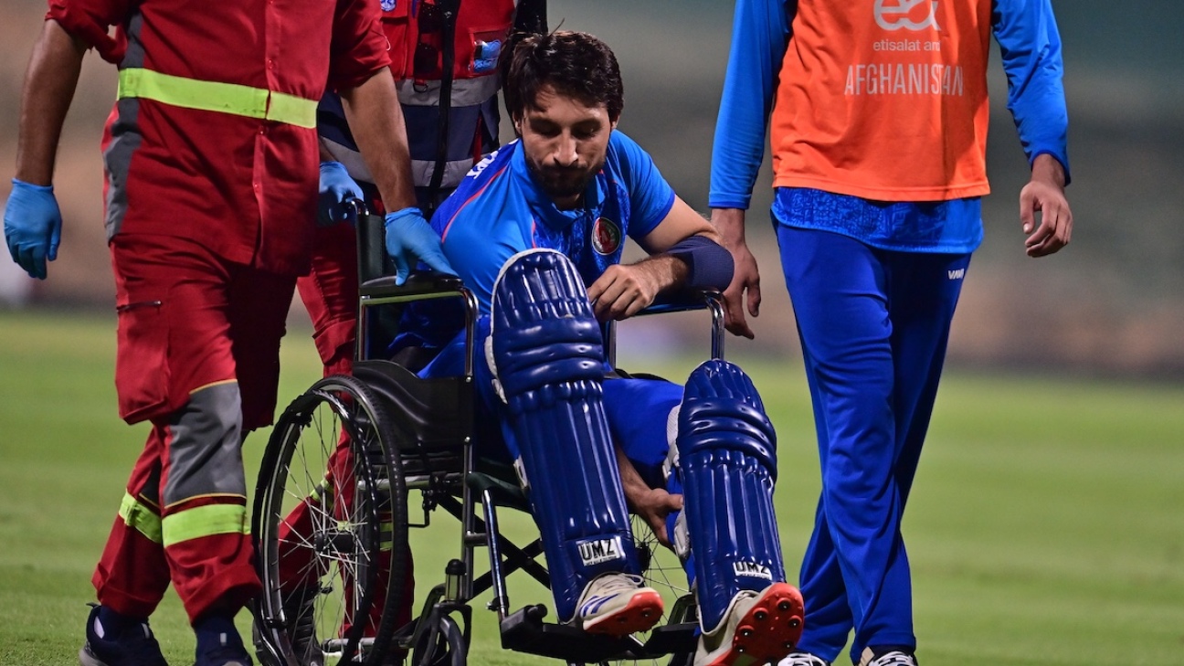 Rahmat leaves the field in a wheelchair after suffering calf injury