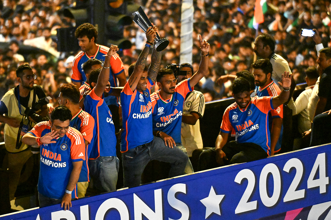 Crowd pleaser: Axar Patel (fifth from left) and his team-mates soak in the adulation during the open-top bus parade in Mumbai after winning the 2024 T20 World Cup