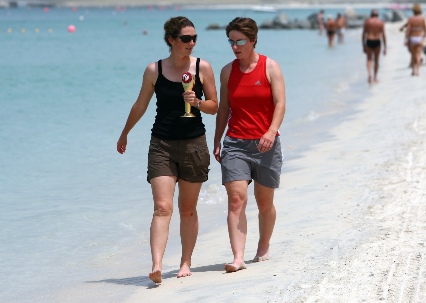 Beach belles: Edwards, armed with her ICC Women's Cricketer of the Year award, in Dubai with Claire Taylor in 2008