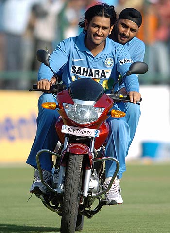 Mahendra Singh Dhoni and Harbhajan Singh take the bike for a spin in the outfield | Photo | Global | ESPNcricinfo.com