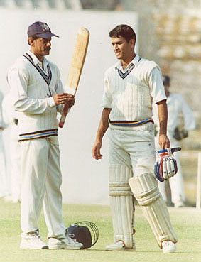 Utpal Chatterjee taking a look at MS Dhoni's bat in between the overs |  Photo | Global | ESPNcricinfo.com